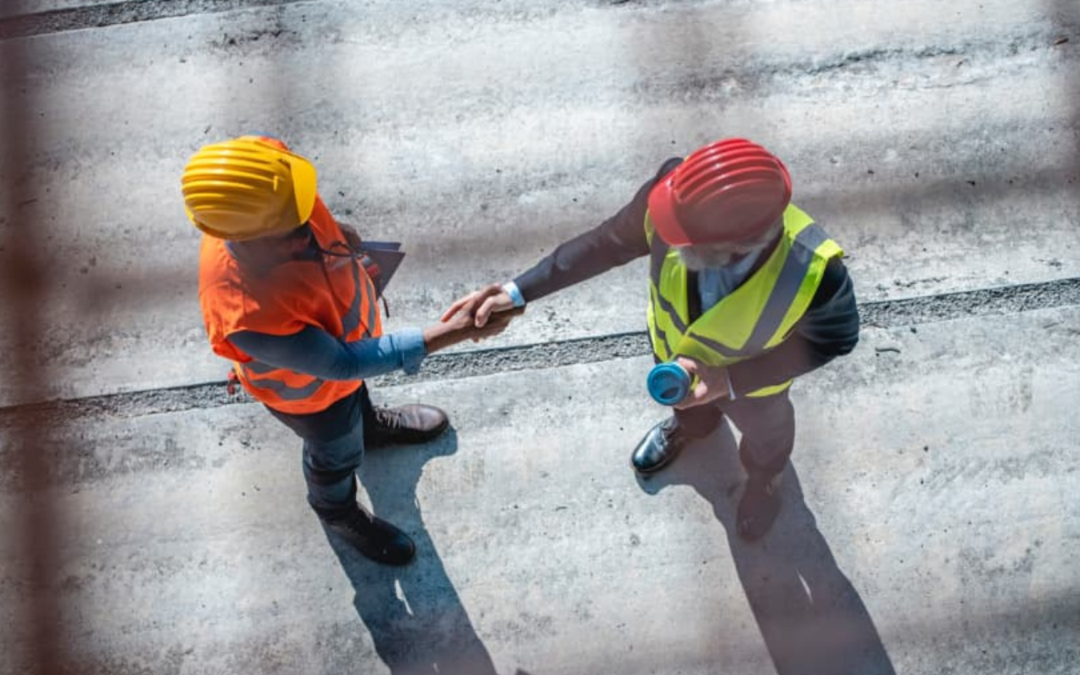 Business owner and Meritus Group broker shaking hands, symbolizing a successful partnership in selling a business
